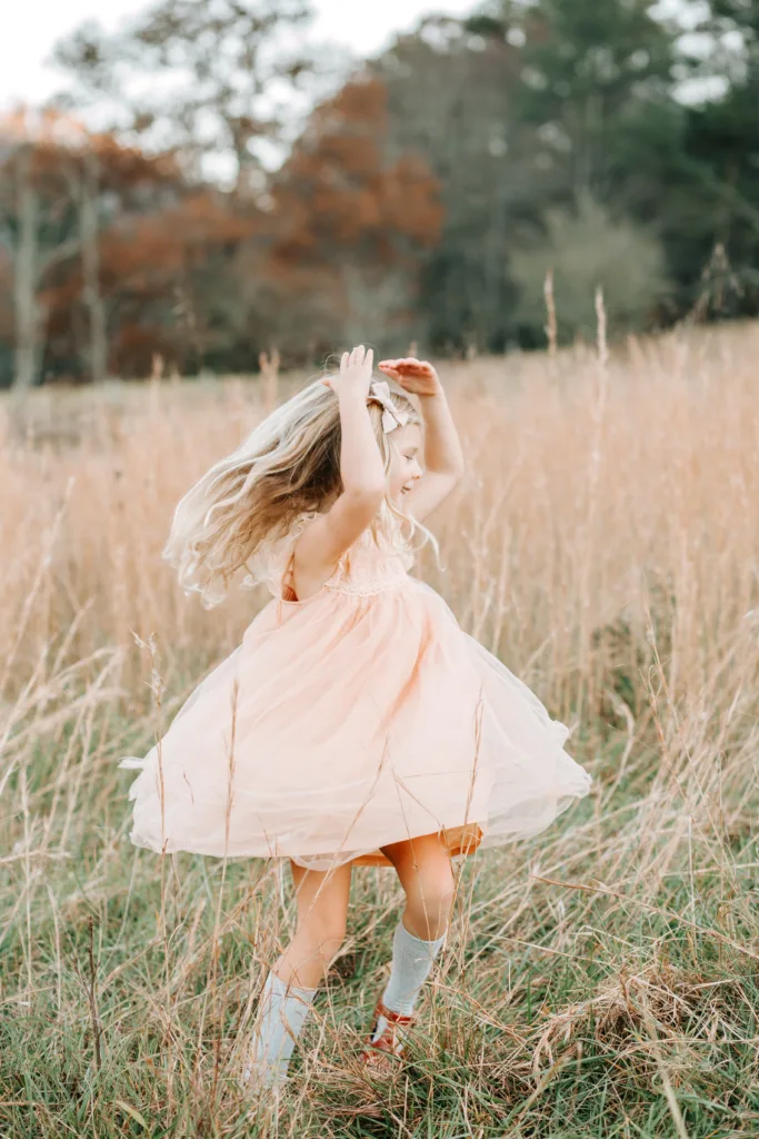 young girl dancing in a meadow